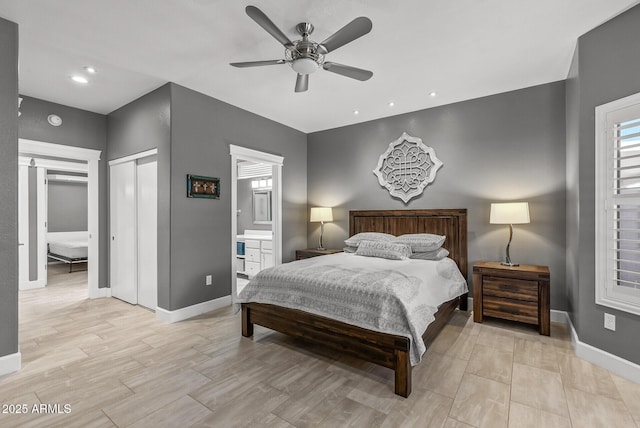 bedroom featuring a ceiling fan, baseboards, light wood finished floors, and connected bathroom