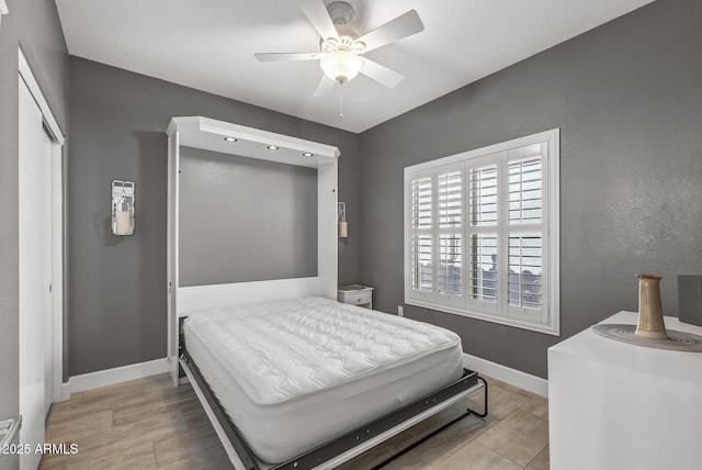 bedroom featuring baseboards and ceiling fan