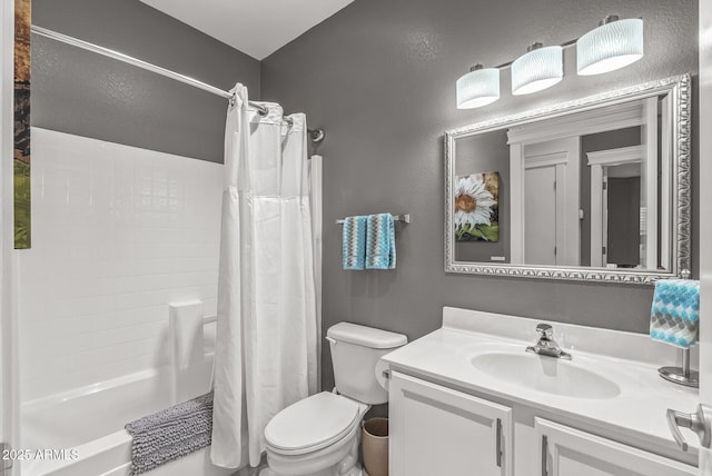 bathroom with vanity, shower / bath combination with curtain, and toilet