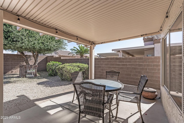 view of patio / terrace with outdoor dining area and fence