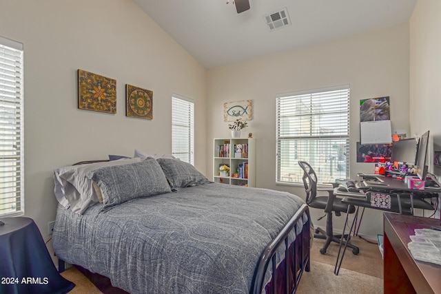 bedroom featuring vaulted ceiling, light carpet, and ceiling fan