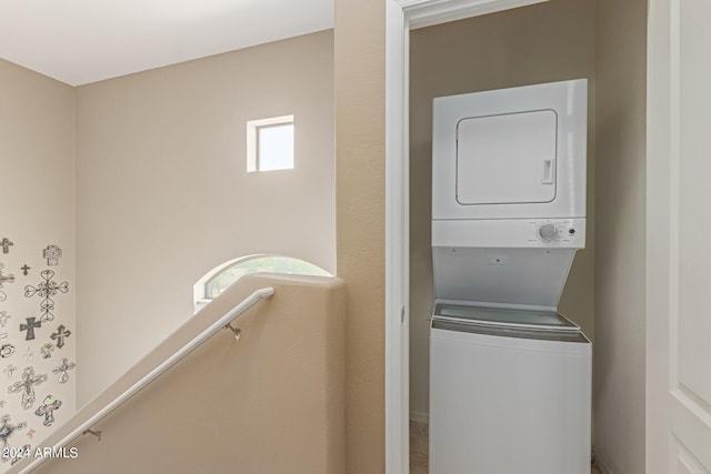 laundry area with stacked washer / dryer