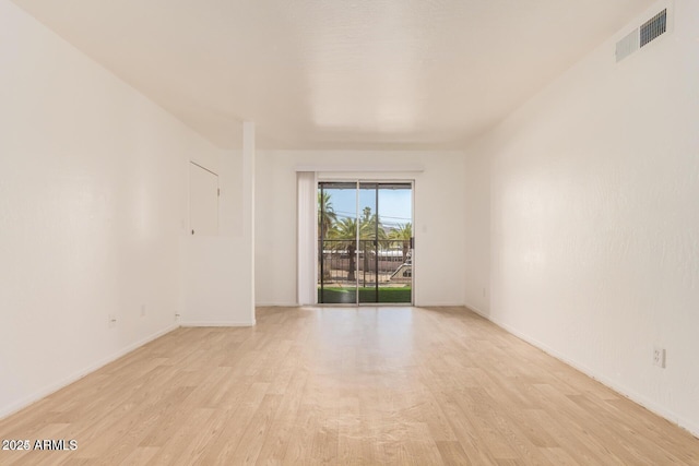 empty room featuring light wood-style floors and baseboards