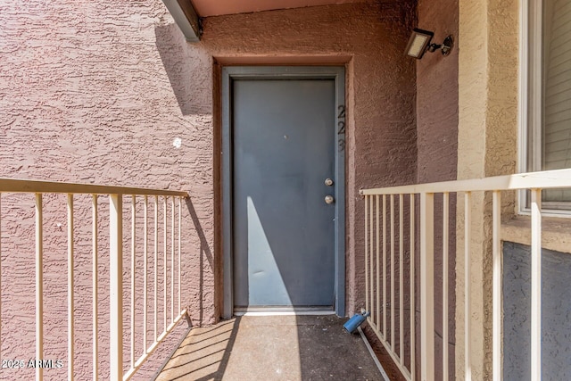 doorway to property with stucco siding