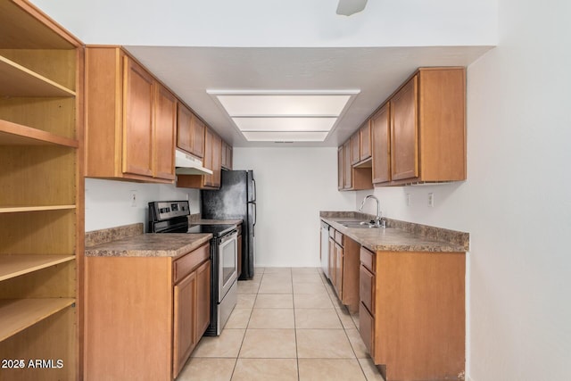 kitchen with stainless steel electric stove, a sink, dark countertops, under cabinet range hood, and light tile patterned floors