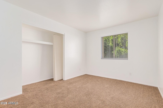 unfurnished bedroom with light carpet and baseboards