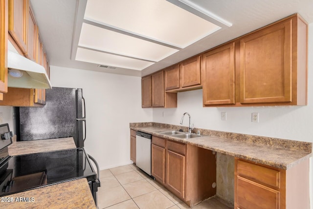 kitchen featuring black appliances, a sink, brown cabinetry, and light tile patterned flooring