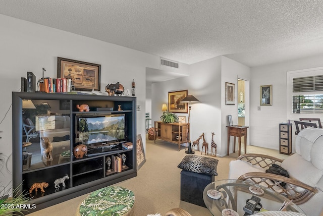 living area with visible vents, a textured ceiling, and light colored carpet
