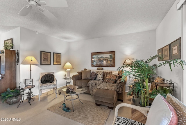 carpeted living room featuring a textured ceiling and ceiling fan