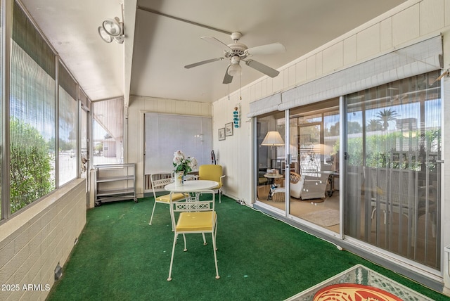 sunroom with beamed ceiling and ceiling fan