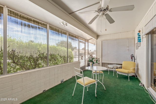 unfurnished sunroom with a ceiling fan
