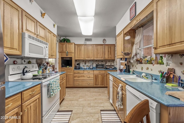 kitchen with a toaster, white appliances, a sink, visible vents, and tasteful backsplash