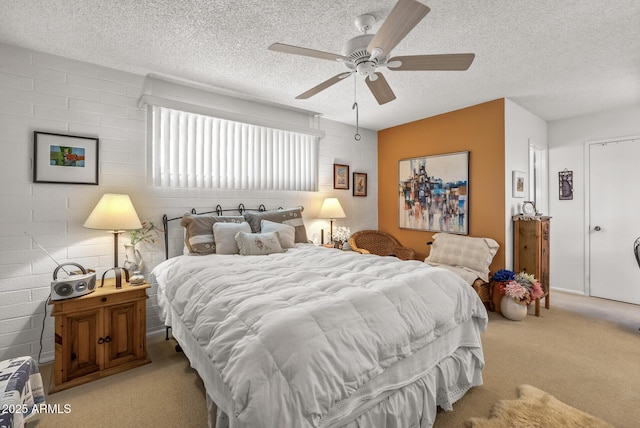 bedroom featuring light carpet, ceiling fan, and a textured ceiling