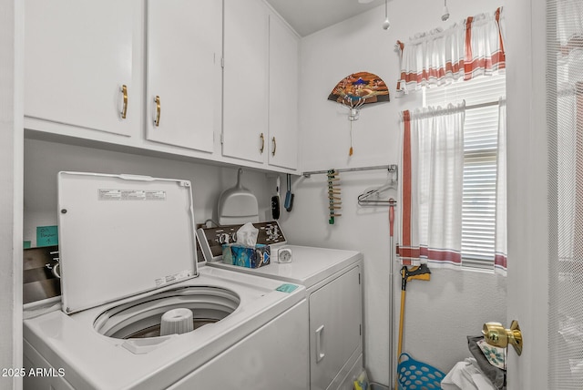 laundry room featuring washing machine and dryer and cabinet space