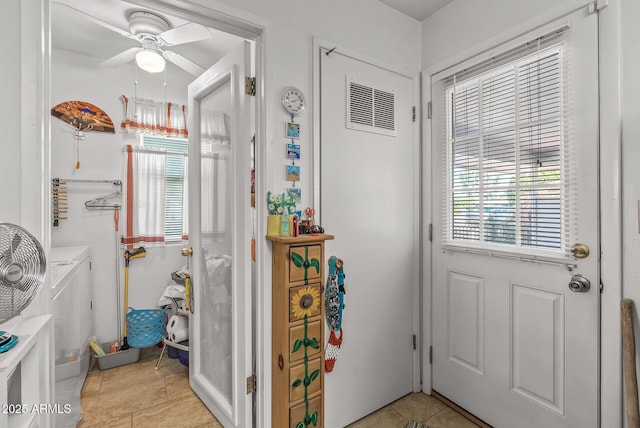 interior space with light tile patterned floors and ceiling fan