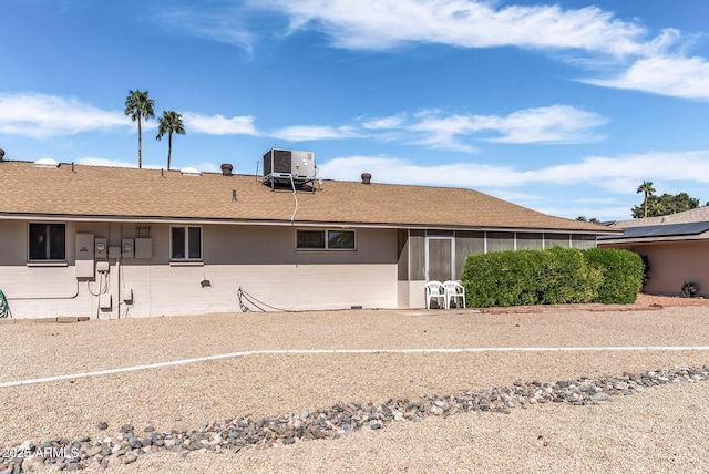 back of house featuring central AC unit