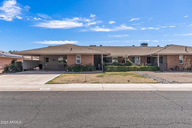 ranch-style house with an attached carport and concrete driveway