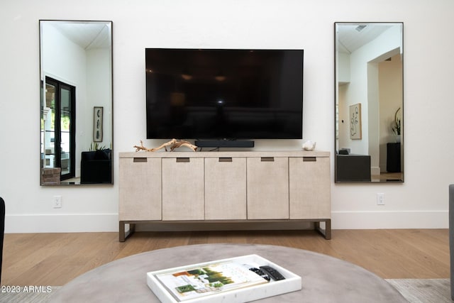 living room featuring light wood-style flooring and baseboards