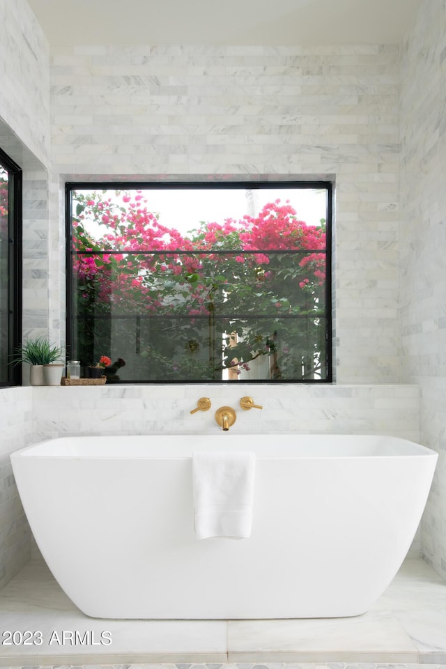 full bathroom with a soaking tub