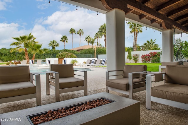 view of patio with a fenced backyard, an outdoor living space with a fire pit, and a fenced in pool