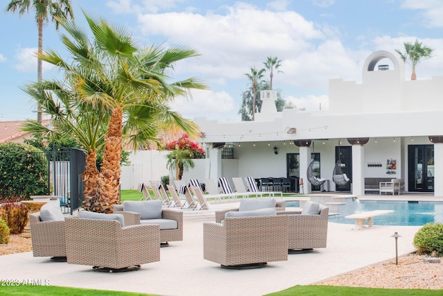 view of patio with an outdoor pool, visible vents, fence, and an outdoor hangout area