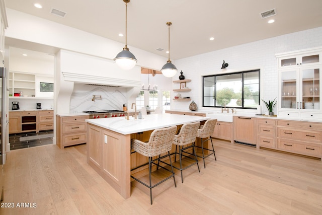 kitchen with light countertops, visible vents, light wood finished floors, and light brown cabinetry