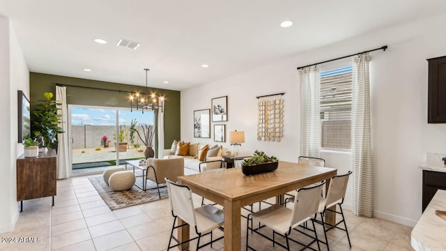 tiled dining space with a notable chandelier