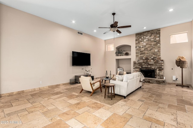 living area with visible vents, built in features, stone tile flooring, ceiling fan, and recessed lighting
