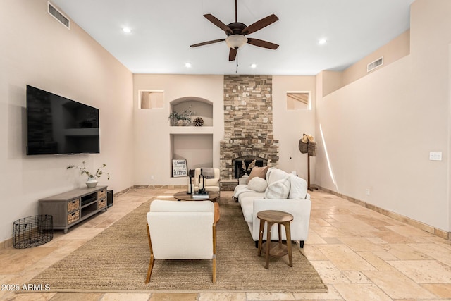 living area featuring recessed lighting, visible vents, stone tile floors, and a ceiling fan