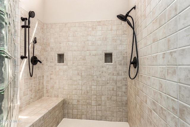 full bath with a tile shower
