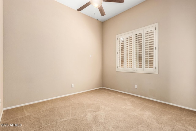 spare room with baseboards, a ceiling fan, and carpet