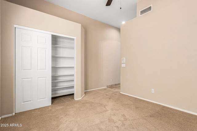 unfurnished bedroom featuring ceiling fan, carpet flooring, baseboards, and visible vents