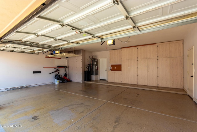 garage featuring water heater and a garage door opener