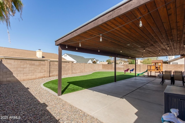 view of patio / terrace featuring a playground and a fenced backyard