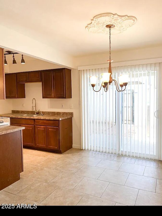 kitchen with sink, a chandelier, and decorative light fixtures