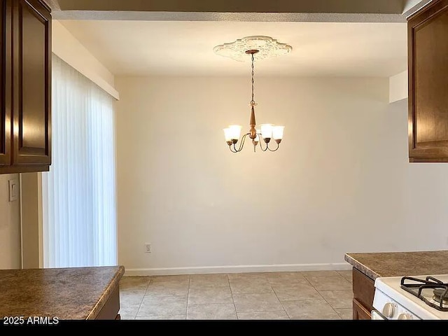 unfurnished dining area with a chandelier and light tile patterned flooring