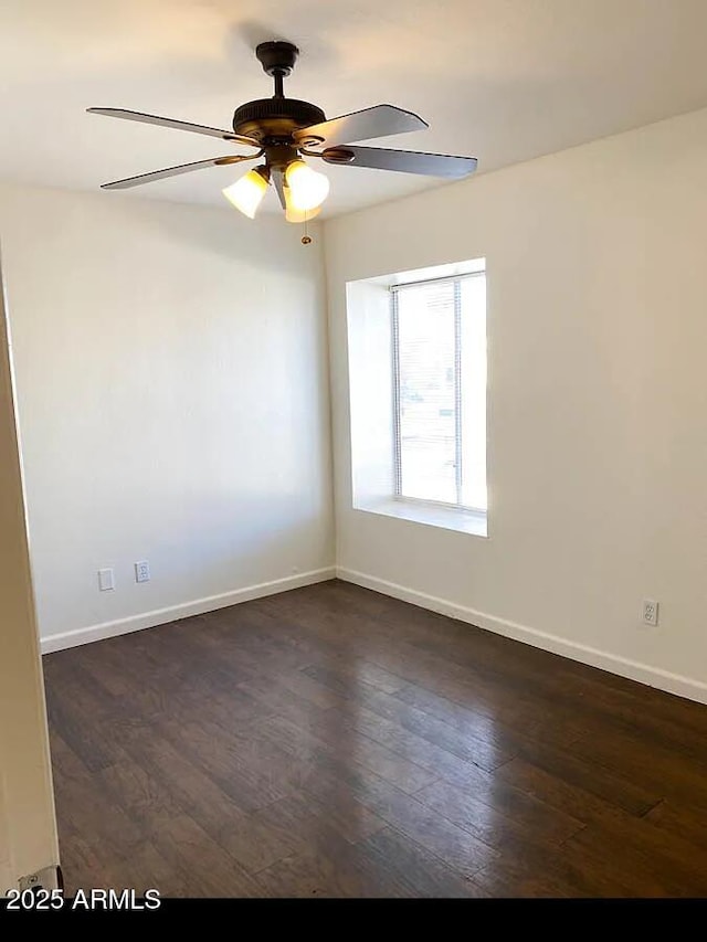 empty room featuring dark hardwood / wood-style floors and ceiling fan