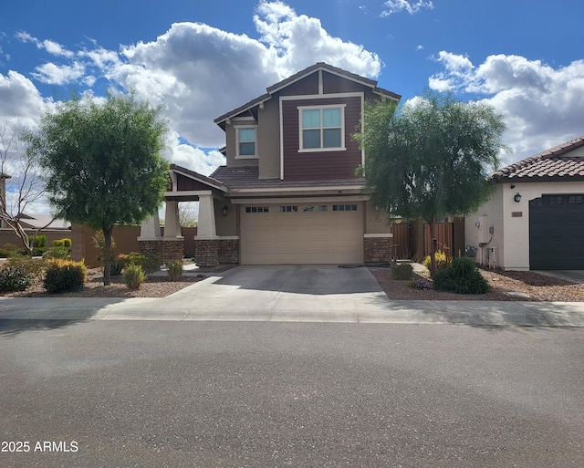 craftsman inspired home with stucco siding, concrete driveway, and a garage