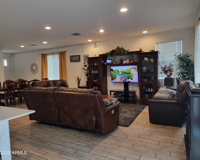 living area featuring wood finish floors, visible vents, and recessed lighting