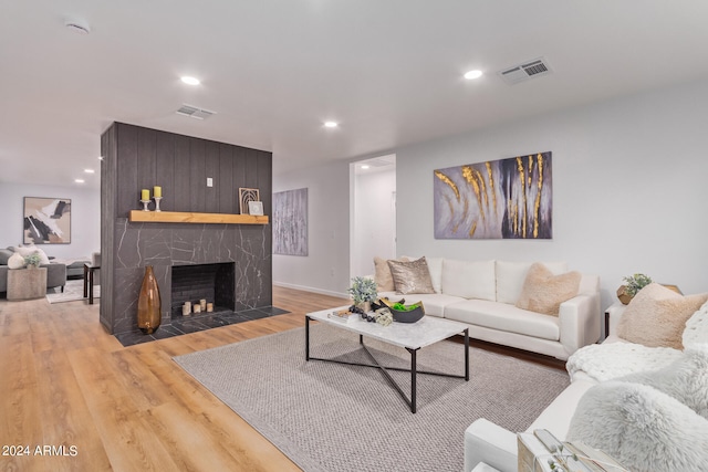 living room with hardwood / wood-style floors and a fireplace