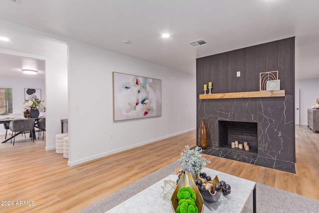 living room with hardwood / wood-style floors and a tile fireplace