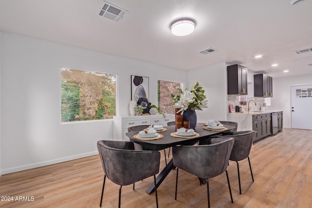 dining space featuring light hardwood / wood-style flooring and sink