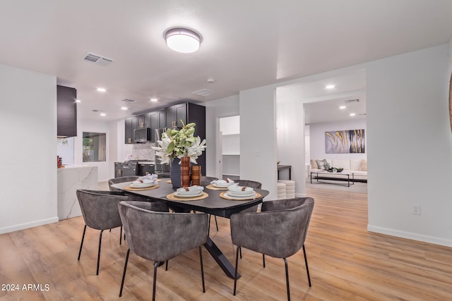 dining area with light hardwood / wood-style floors