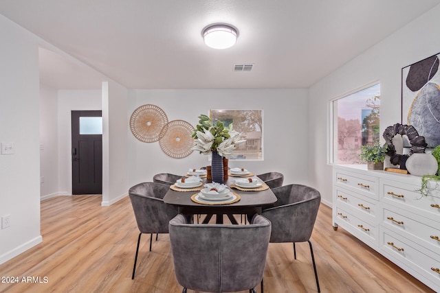 dining area with light hardwood / wood-style floors