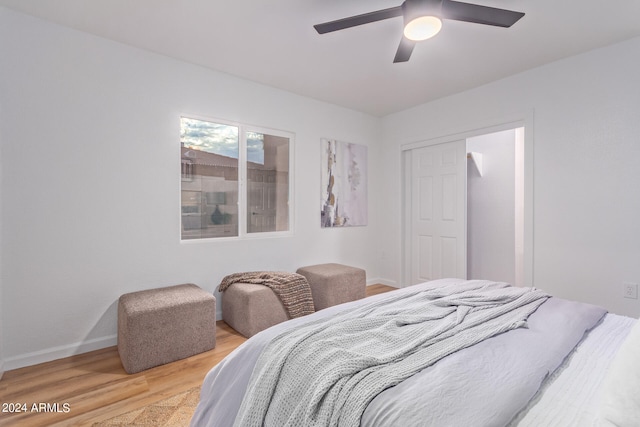 bedroom with ceiling fan, a closet, and light wood-type flooring