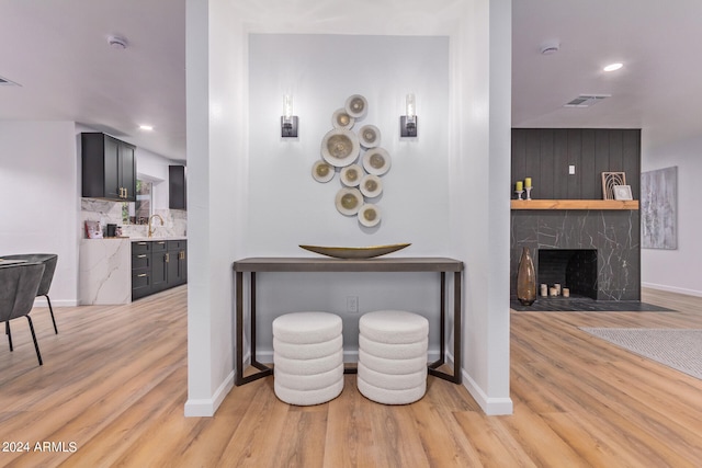 hall featuring sink and light hardwood / wood-style floors