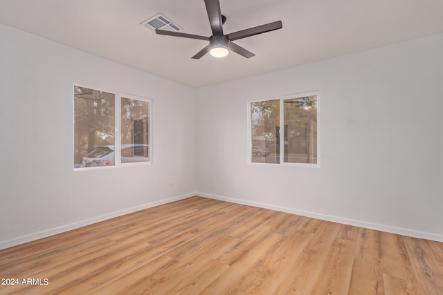 empty room with light hardwood / wood-style flooring and ceiling fan