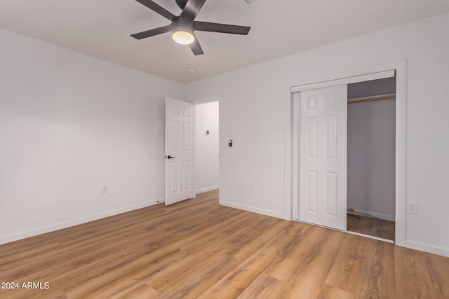 unfurnished bedroom with a closet, wood-type flooring, and ceiling fan