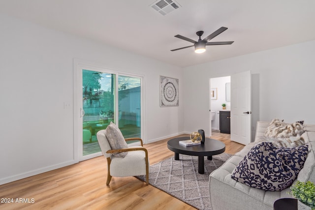 living room with ceiling fan and light wood-type flooring