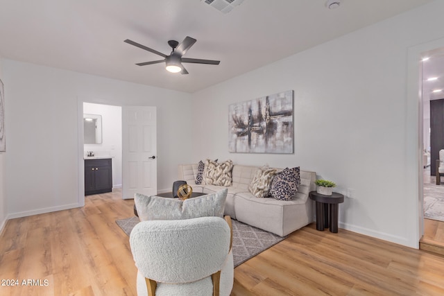 living room with light wood-type flooring and ceiling fan